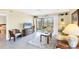 Comfortable living room with a TV, neutral furniture, and access to a screened-in lanai at 6610 Gasparilla Pines Blvd # 113, Englewood, FL 34224