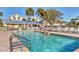 Relax at the community pool surrounded by well-maintained grounds and comfortable seating at 6610 Gasparilla Pines Blvd # 113, Englewood, FL 34224