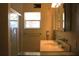 Bathroom featuring a vanity, shower, and window offering natural light at 6980 Tuxedo St, Englewood, FL 34224