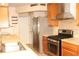 Gourmet kitchen featuring stainless steel appliances, and granite countertops at 6980 Tuxedo St, Englewood, FL 34224