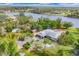 Beautiful aerial view of a riverside property with lush greenery, mature trees, and a charming detached red shed at 730 Buckskin Ct, Englewood, FL 34223