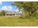 The lush green lawn that surrounds the property offers a serene environment and complements the home's exterior at 730 Buckskin Ct, Englewood, FL 34223