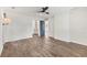 Bedroom with wood floors, ceiling fan, and entrance to the ensuite bathroom at 730 Buckskin Ct, Englewood, FL 34223