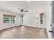 Bedroom with wood floors, ceiling fan, and windows with backyard views at 730 Buckskin Ct, Englewood, FL 34223