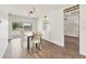 Dining room with wood floors, shiplap wall, and sliding door to backyard at 730 Buckskin Ct, Englewood, FL 34223