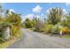 This home's driveway is long and private, flanked by lush greenery and flowering shrubs at 730 Buckskin Ct, Englewood, FL 34223