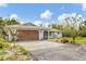 Charming one-story home with a two-car garage, mature landscaping and freshly painted exterior at 730 Buckskin Ct, Englewood, FL 34223