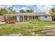 A charming one-story home features a well-kept lawn and a two car garage at 730 Buckskin Ct, Englewood, FL 34223