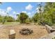 Inviting fire pit area with benches, perfect for outdoor gatherings and enjoying the natural surroundings at 730 Buckskin Ct, Englewood, FL 34223