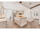 Bright kitchen features a butcher block island with prep sink, stainless appliances, and wood-look tile flooring at 730 Buckskin Ct, Englewood, FL 34223