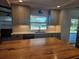 Modern kitchen with gray cabinets, white backsplash, and island with butcher block countertop at 730 Buckskin Ct, Englewood, FL 34223