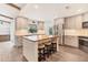 Open kitchen boasts a butcher block island with seating, stainless appliances, and stylish gray cabinetry at 730 Buckskin Ct, Englewood, FL 34223