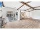 An open floor plan features tile flooring, wood beams and plenty of natural light at 730 Buckskin Ct, Englewood, FL 34223