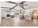 Inviting living room open to kitchen boasts wood beams, tile floors and fireplace at 730 Buckskin Ct, Englewood, FL 34223