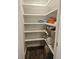 Well-organized pantry with white shelves, wood floor, and ample storage space at 730 Buckskin Ct, Englewood, FL 34223