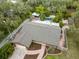 Aerial view of a private home showcasing mature trees, a pool and spa area and a fenced yard at 746 Brentwood Dr, Venice, FL 34292
