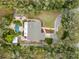 Aerial view of a home with a pool surrounded by lush landscaping and a winding driveway at 746 Brentwood Dr, Venice, FL 34292