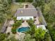 Overhead view of a secluded property with a pool area and lush landscaping, accessible via a winding driveway at 746 Brentwood Dr, Venice, FL 34292