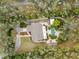 Aerial view showcasing a home with a pool area nestled among dense trees and a circular driveway at 746 Brentwood Dr, Venice, FL 34292