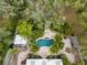 Aerial view of a private pool surrounded by tropical landscaping and brickwork, with a cabana and pergola at 746 Brentwood Dr, Venice, FL 34292