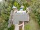 Aerial view of the property featuring a fenced-in pool, well-manicured yard, and lush landscaping at 746 Brentwood Dr, Venice, FL 34292