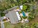 Aerial view of a home with a private pool area, tropical landscaping, and charming outdoor spaces at 746 Brentwood Dr, Venice, FL 34292