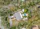 Overhead shot of a home with a pool, greenery, and a driveway, surrounded by mature trees at 746 Brentwood Dr, Venice, FL 34292