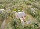 Bird's-eye view of the home, showcasing a private pool, well-maintained yard, and surrounding wooded area at 746 Brentwood Dr, Venice, FL 34292