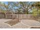 A backyard with pavers, a wooden pergola, a lamp post, and a brown fence at 746 Brentwood Dr, Venice, FL 34292