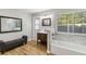 Bathroom featuring a modern vanity, a tub, and a bench at 746 Brentwood Dr, Venice, FL 34292