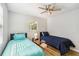 Bright bedroom with two twin beds, ceiling fan, and natural light at 746 Brentwood Dr, Venice, FL 34292