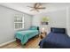 Bright bedroom with two twin beds, ceiling fan, and natural light at 746 Brentwood Dr, Venice, FL 34292