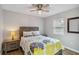 Cozy bedroom with a ceiling fan, side tables, and a window that provides natural light at 746 Brentwood Dr, Venice, FL 34292