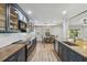 A long view of the open concept eat-in kitchen, with stainless appliances and modern cabinets at 746 Brentwood Dr, Venice, FL 34292
