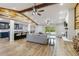 Spacious open concept living area with exposed wood beams and a brick fireplace at 746 Brentwood Dr, Venice, FL 34292