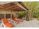 Relaxing outdoor lounge space with three chairs and a wooden pergola at 746 Brentwood Dr, Venice, FL 34292