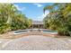 Backyard with a pool surrounded by lush greenery and stone pavers at 746 Brentwood Dr, Venice, FL 34292