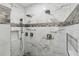 Walk-in shower featuring double shower heads, marble tiling, and mosaic accents at 746 Brentwood Dr, Venice, FL 34292