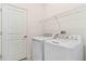 Clean laundry room features a modern washer and dryer for convenience at 8077 Shore Lake Dr, Englewood, FL 34224