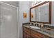Updated bathroom with a granite countertop vanity, shell decor, and glass-enclosed shower at 8409 Placida Rd # 305, Placida, FL 33946
