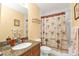 Well-lit bathroom featuring a granite vanity, modern fixtures, and a shower with a palm tree curtain at 8409 Placida Rd # 305, Placida, FL 33946
