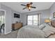 Comfortable bedroom featuring a large window, ceiling fan, and carpeted floor at 8409 Placida Rd # 305, Placida, FL 33946