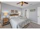 Comfortable bedroom with a large window, ceiling fan, and carpeted floor at 8409 Placida Rd # 305, Placida, FL 33946