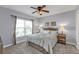 Comfortable bedroom with a large window, ceiling fan, and carpeted floor at 8409 Placida Rd # 305, Placida, FL 33946