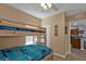 Cozy bedroom with a bunk bed, ceiling fan, and view to kitchen area at 8409 Placida Rd # 305, Placida, FL 33946