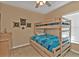 Bright bedroom featuring a wooden bunk bed, nautical decor, and a window at 8409 Placida Rd # 305, Placida, FL 33946