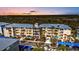 Exterior of the colorful building with balconies, palm trees, and ample parking at 8409 Placida Rd # 305, Placida, FL 33946