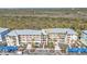 Condo building featuring balconies, covered parking and tropical landscaping at 8409 Placida Rd # 305, Placida, FL 33946
