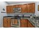 Stainless steel appliances accent the wood cabinetry and dark granite countertops at 8409 Placida Rd # 305, Placida, FL 33946