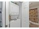 Efficient stacked washer and dryer, conveniently located near the bathroom at 8409 Placida Rd # 305, Placida, FL 33946